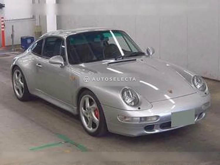 Front interior of a 1996 Porsche 911 Carrera S 993 showing black leather seat, dashboard and automatic selector