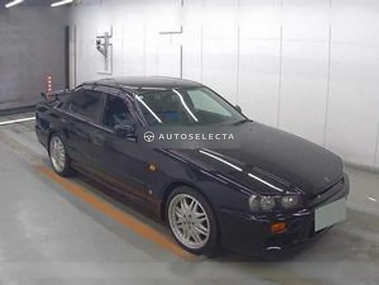 Black 1999 Nissan Skyline 25GT-X ER34 front right three quarter view with alloy wheels and rear spoiler